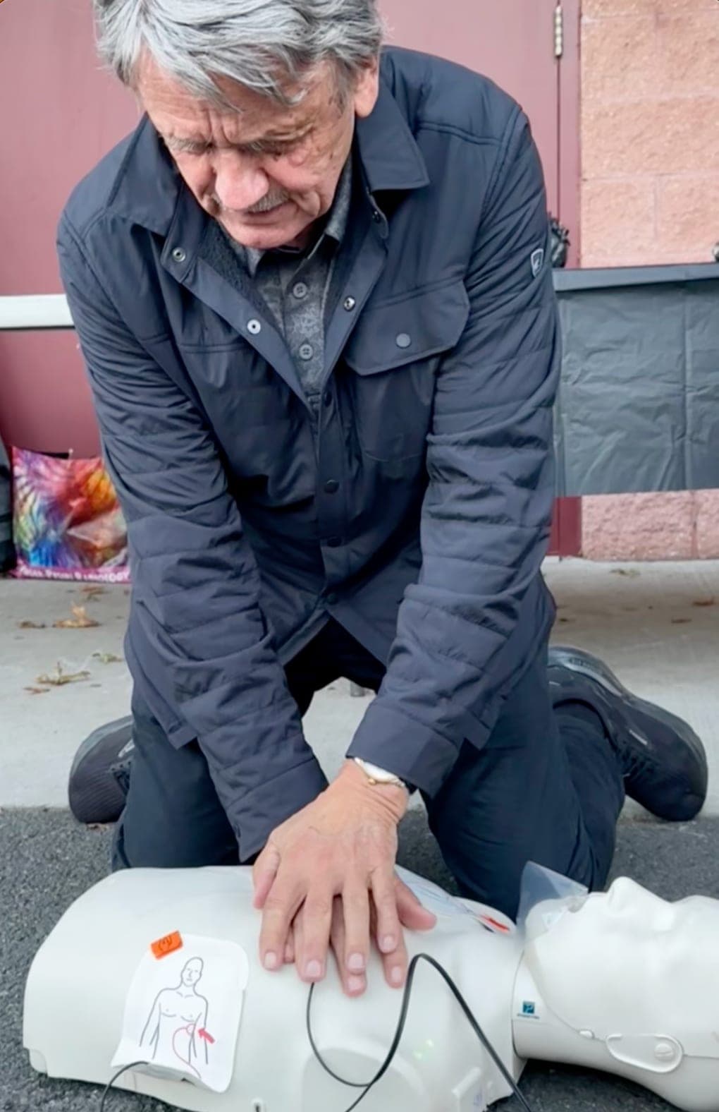 Glenn “Chico” Resch practices CPR compressions during the October 2024 event at La Grande Park.